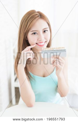 woman with tooth color palette at home