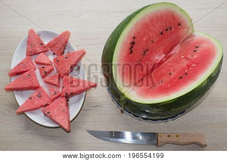 Slices of juicy and tasty watermelon on a white plate. Refreshing desserts of watermelon