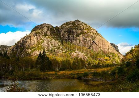 massive rocks at fjord landscape in norway during sunny autumn day