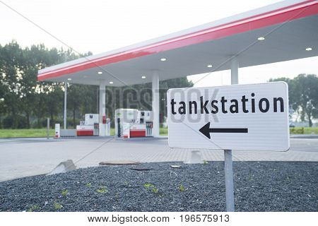 direction shield in front of an unmanned gas station in the netherlands
