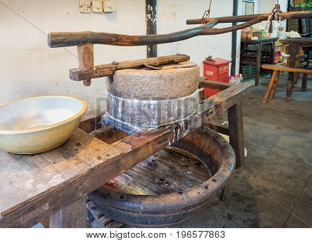 Suzhou, China - Nov 5, 2016: Small traditional stone mill on display in a shop at the historic Zhouzhuang Water Town.