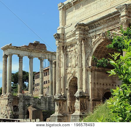 Arch of Emperor Septimius Severus and Temple of Saturn at the Roman Forum in Rome, Italy