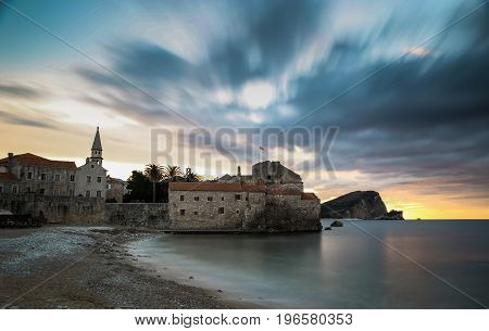Clouds over the sea and the old city at sunrise
