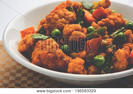 indian spicy food Gobi matar Masala or cauliflower curry with green peas or phool gobi fry, selective focus