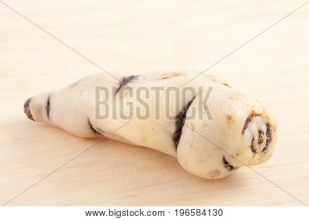 Cubios (Tropaeolum tuberosum) on light wooden background