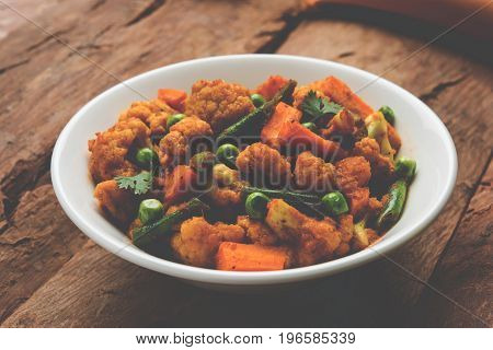 indian spicy food Gobi matar Masala or cauliflower curry with green peas or phool gobi fry, selective focus