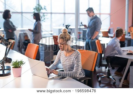 Young female Entrepreneur Freelancer Working Using A Laptop In Coworking space