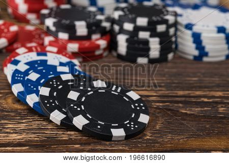 Poker chips scattered on the background of a wooden table