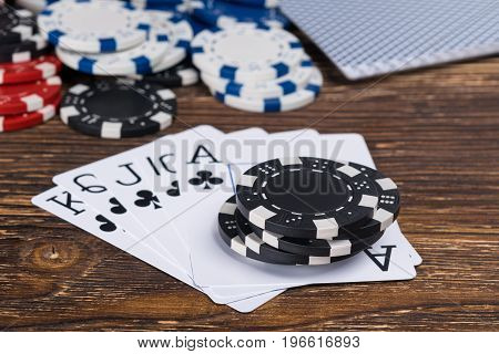 Set of cards from black suits in poker on the background of the old table