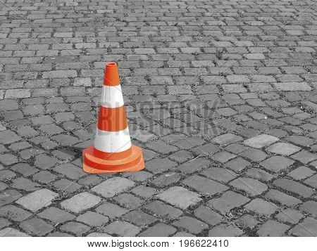 Pylon on a coblestone secure or safety concept background with space for text or image