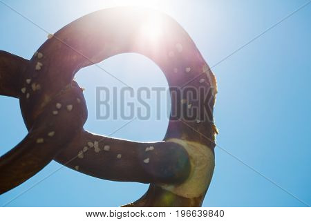 pretzel the sky with sun, brezn, germany, munich