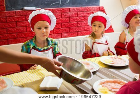 Alchevsk, Ukraine - July 23, 2017: School Cook For Children. Meat Rolls With Cheese Are Prepared.