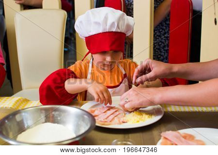 Alchevsk, Ukraine - July 23, 2017: School Cook For Children. Meat Rolls With Cheese Are Prepared.