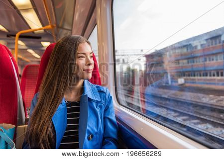 Train woman leaving for work in morning commute commuting to city. Urban travel businesswoman traveling on rails.