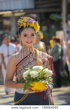CHIANGMAI THAILAND - JANUARY 25 2015: Indigenous girl with local traditional costume with a bowl of white flowers in parade of 22nd Traditional Skirt Fabric and The Indigenous Product and Culture Festival in Mae Chaem Chiangmai Thailand