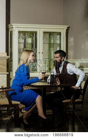 Couple In Love Sitting With Martini Glasses At Table