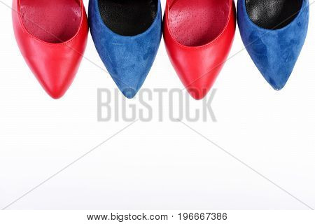 Accessories for women. Fashion and beauty concept.Blue and red female shoes showing toecaps only. Formal footwear with copy space. Shoe toes isolated on white background.