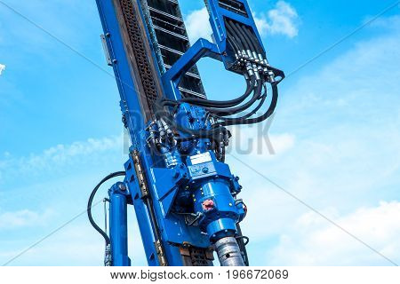 part of hydraulic drilling rig in sky with clouds