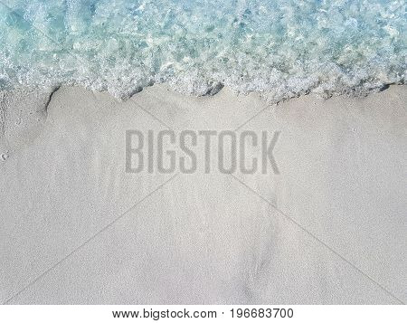 calm blue sea waves hitting silver sand beach at Cheshme Turkey