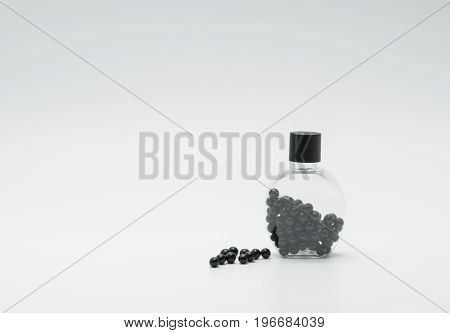 Thai herbal medicine in plastic bottle with modern design and many pills spread on a white background bolus