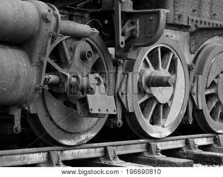 old steam locomotive with rusted wheels and missing parts