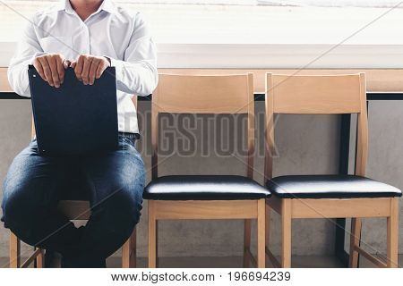 interview recruitment concept Businessman holdind portfolio report while sitting on chair. Tired of waiting Human Resources Waiting for interview.