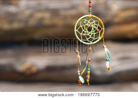 Dream catcher in the wind on a wooden background