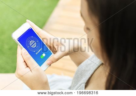 Asian woman hand holding mobile phone and connecting data roaming for calling or use internet