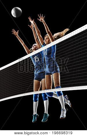Female professional volleyball players isolated on black background