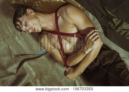 A young and sexy naked guy lies on the floor
