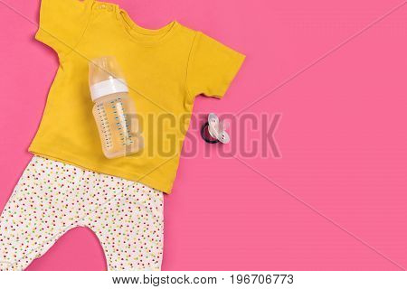 Baby clothes and accessories on pink background. Top view. Copy space. Still life. Flat lay