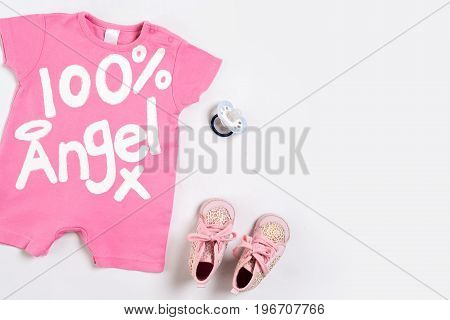Baby clothes and accessories on white background. Top view. Copy space. Still life. Flat lay