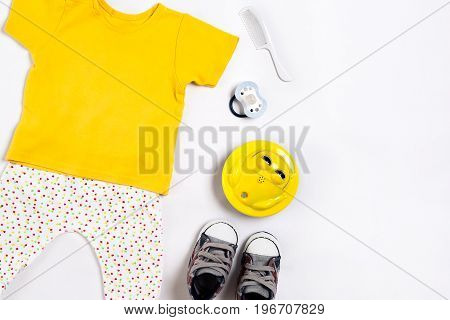 Baby clothes and accessories on white background. Top view. Copy space. Still life. Flat lay