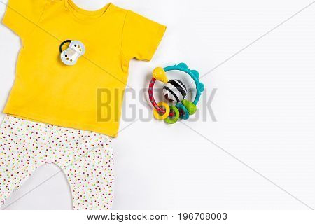 Baby clothes and accessories on white background. Top view. Copy space. Still life. Flat lay