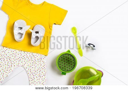 Baby clothes and accessories on white background. Top view. Copy space. Still life. Flat lay