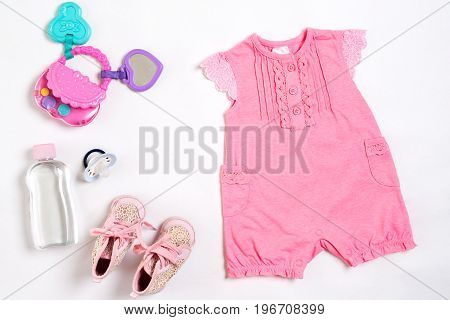 Baby clothes and accessories on white background. Top view. Copy space. Still life. Flat lay