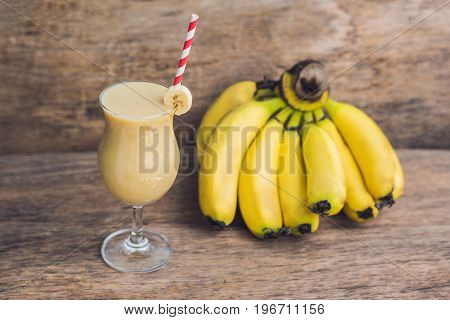 Banana Smoothies And Bananas On An Old Wooden Background