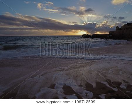 Beautiful Sunset Ond The Sand Beach Sea Shore With Sandstone Cliffs And Dramatic Sky