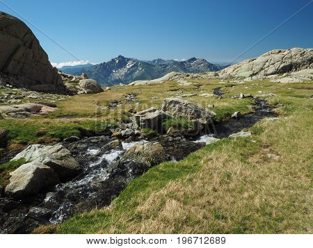 Mountain Wild Spring On The Green Meadow And Rocks