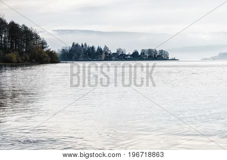 Beautiful view of Lipno lake peninsula lost in fog. Nice and smooth surface.
