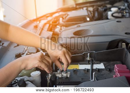 Hand of woman checking car and battery broke