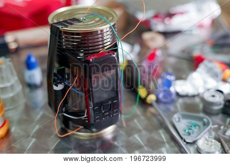 Homemade bomb with a cellphone timer, on a blurred background.
