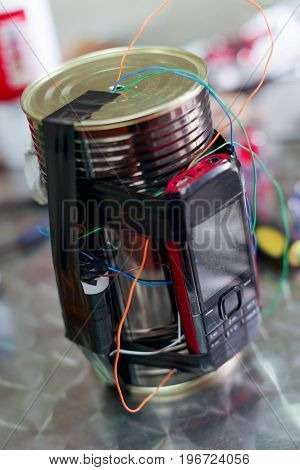 Homemade bomb with a cellphone timer, on a blurred background.