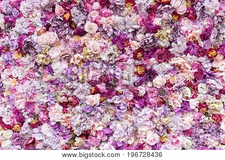 Flower texture background for wedding scene. Roses, peonies and hydrangeas, artificial flowers on the wall