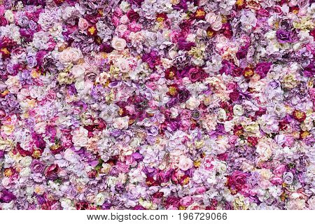 Flower texture background for wedding scene. Roses, peonies and hydrangeas, artificial flowers on the wall