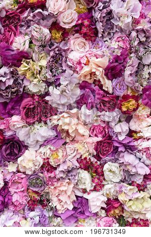 Flower texture background for wedding scene. Roses, peonies and hydrangeas, artificial flowers on the wall