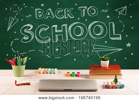 Back to school concepty with writing on blackboard and desk, apple, books, items