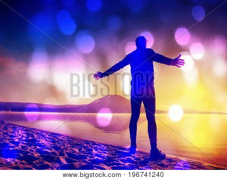 Film Effect. Man Exercising On The Beach.  Silhouette Of Active Man Exercising  And Stretching On Th