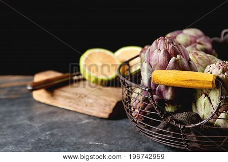 Baby Ripping Organic Artichokes With Lemon. Food For A Vegan And