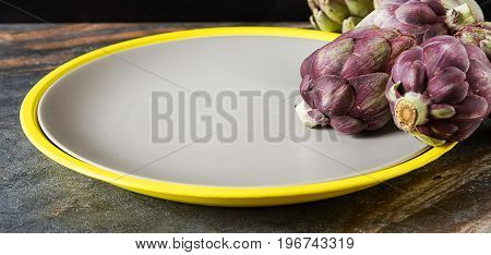 Baby Ripping Organic Artichokes With Lemon. Food For A Vegan And